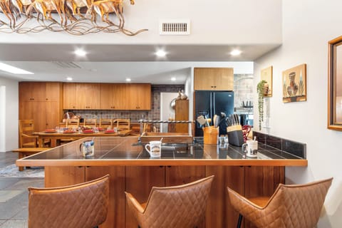 Dining room with bar seating for three.