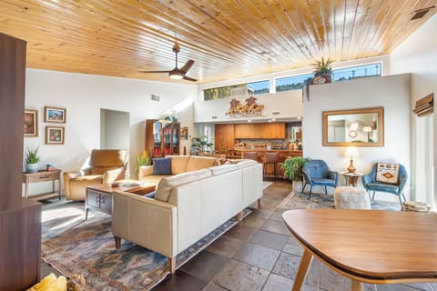 Living room-hardwood floors, and sliding glass doors that open onto the covered patio, seamlessly blending indoor and outdoor spaces.