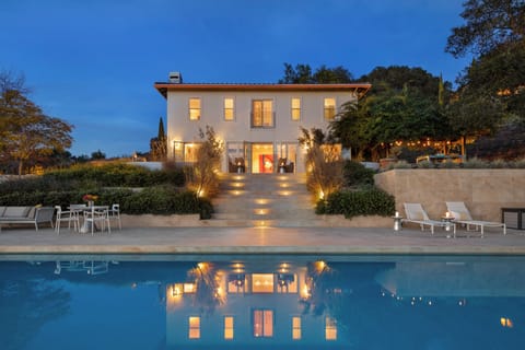 Backyard's pool area with multiple seating option.