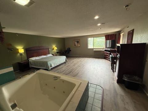 Room, 1 King Bed, Non Smoking, Jetted Tub | Desk, iron/ironing board, free WiFi, bed sheets