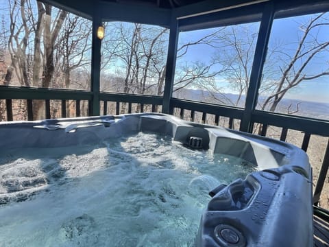 Screened in, outdoor hot tub with a view