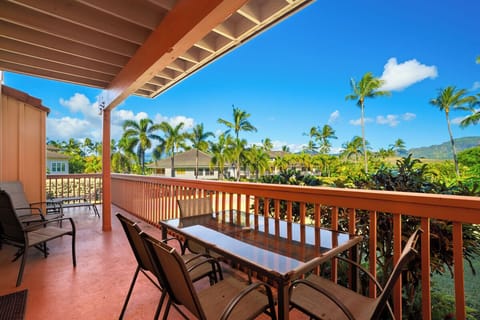 Your private balcony offers stunning tropical views with swaying palms and mountain vistas—perfect for morning coffee or sunset cocktails.