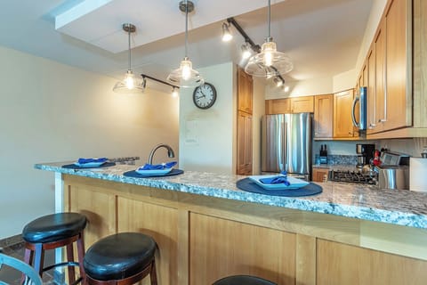 A beautiful kitchen with a three seat bar made for together time