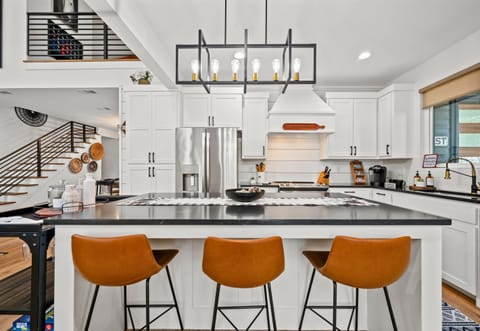 Seating along the island creates an easy spot for morning coffee, casual meals, or keeping the cook company.