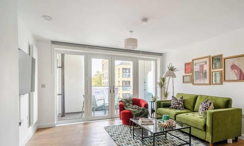 Bright living room with smart TV and balcony access