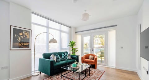Bright living room with smart TV and balcony access