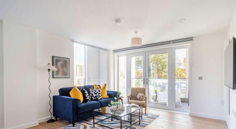 Bright living room with smart TV and balcony access