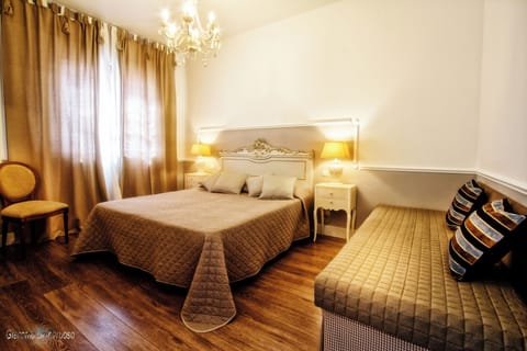 Deluxe Triple Room, Garden View | Blackout drapes, iron/ironing board, free WiFi