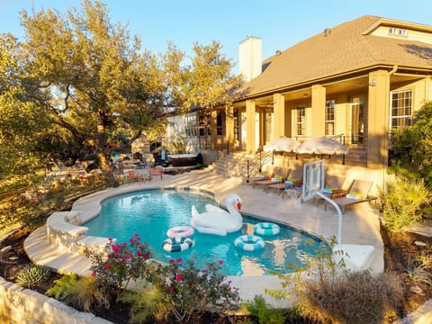 Private backyard with deck, pool (not heated), hot tub and play structure.
