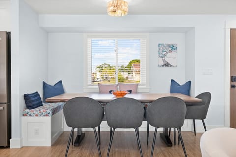 Bright dining nook with custom bench seating and canal views — the perfect spot for family meals or morning coffee.