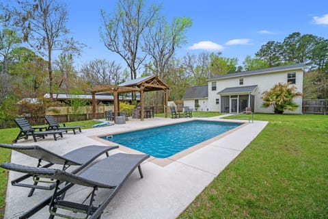 Large Fenced in Private Backyard with a Large Pool, Outdoor Kitchen, Lounge Chairs, Dining Table, a Swinging Bench & More!