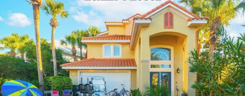 Welcoming front exterior surrounded by palms and vibrant landscaping