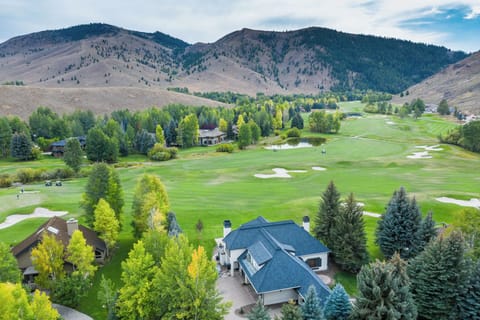 Aerial view of Fairway Twelve Retreat overlooking the 12th fairway with surrounding mountain views.