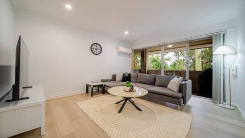 Relaxed lounge opening to leafy outdoor views
