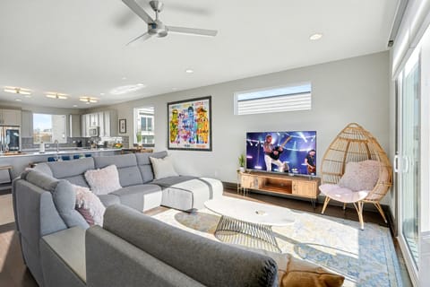 2nd Floor: Bright and open living area with cozy furnishings, a smart TV, Twin daybed with a Twin trundle, and a private balcony.