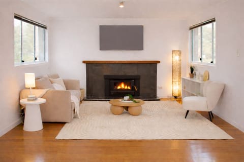 Warm and inviting lounge featuring a fireplace, modern décor, and scenic outlook