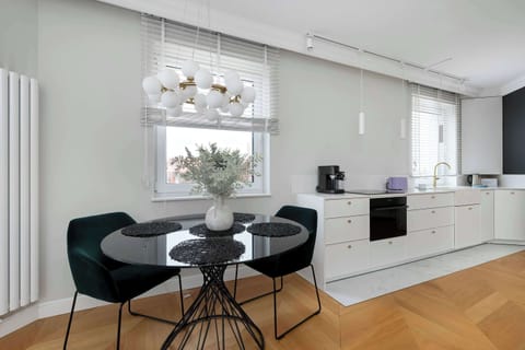 Inviting dining area with round table, modern chairs, and tasteful lighting.