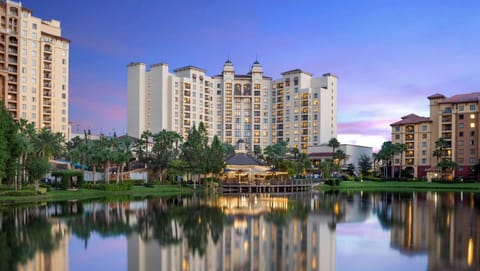Twilight view of resort lit up with lights by the lakeside