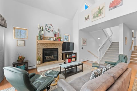 Cozy up in this bright living space featuring a warm fireplace, comfortable seating, and charming décor that makes you feel instantly at home.