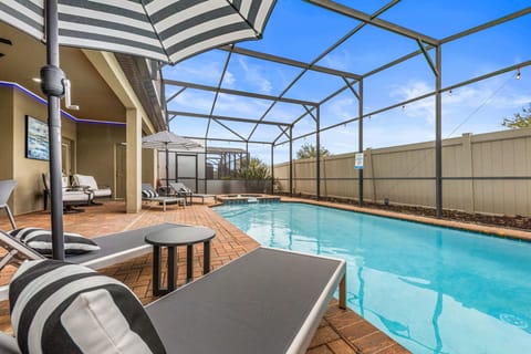 Stay cool under the covered lanai featuring wall-controlled ceiling fans and Florida glass panels for shade and comfort.