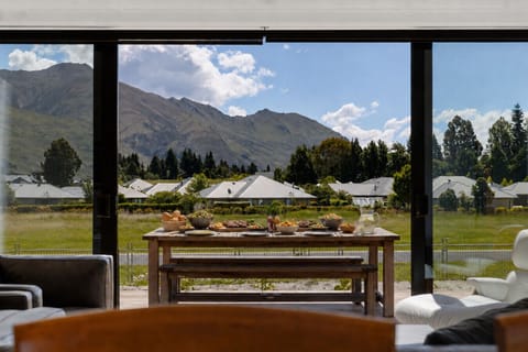 Wake up to this. Floor-to-ceiling windows frame Mt Roy while you linger over breakfast at the dining table.