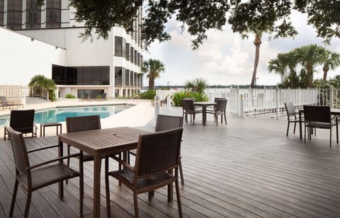 Unwind on spacious decking with palm shade and water vistas.
