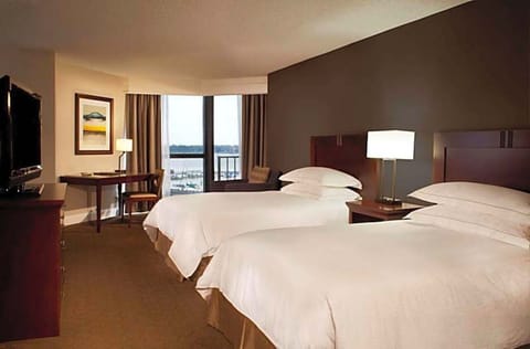 Unwind in airy double-queen comfort with sweeping water views.