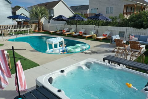 Soak into pure relaxation as the heated pool sparkles beside a bubbling hot tub—your private retreat for sun-soaked afternoons, twilight conversations, and unforgettable memories under Myrtle Beach skies.