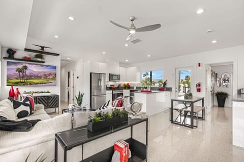 Open living area w/ sleek seating, large TV & easy flow into the kitchen for hanging out together