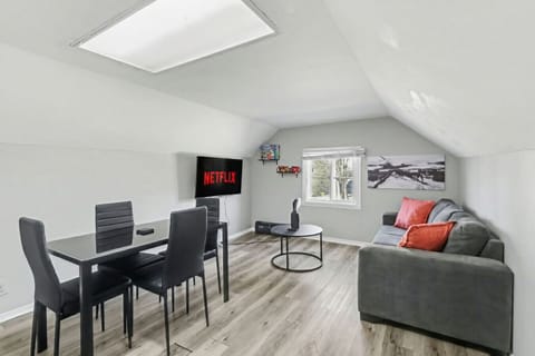 Retreat to this stylish attic hideaway. Whether you are catching a movie on the sofa or enjoying a meal at the sleek dining table, this bright and modern space offers the perfect cozy atmosphere for your next getaway.