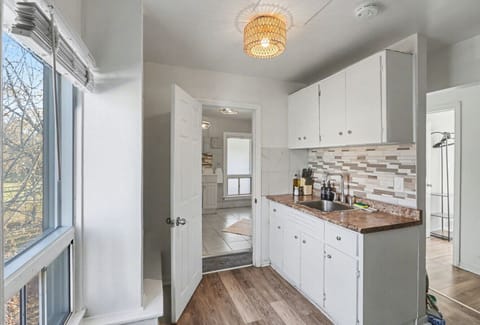 Prepare a delicious meal in this tidy kitchen featuring a full stove and modern tiled backsplash. A bright, inviting space that offers everything you need to feel right at home during your stay.