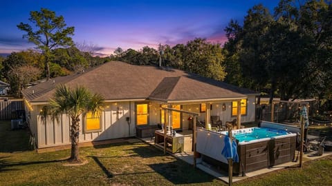 Evenings come alive in the private backyard with the illuminated Catalina Spas swim spa, covered patio, and peaceful outdoor setting.