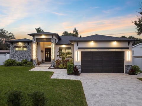 Stunning contemporary exterior with modern lighting for a warm welcome.