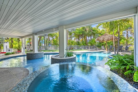 You'll feel like you stepped into a private island escape when you glance at the pool, spa, and cascading waterfall beneath lush palms.