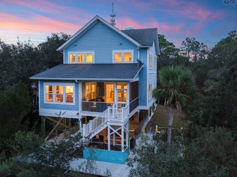 Beautiful elevated beach house exterior at sunset.