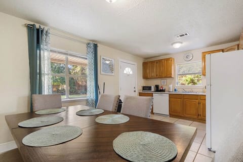 This open dining area flows seamlessly into the kitchen, making it easy to cook, serve, and gather. The roomy table is perfect for shared meals, game nights, or casual conversations during your stay.