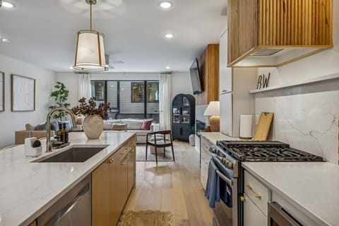 Kitchen: Sleek lines, warm tones, and high-end touches — the perfect kitchen for cooking, entertaining, and enjoying life together.