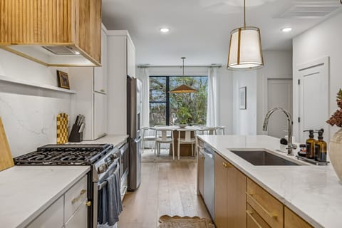 Kitchen: Sleek lines, warm tones, and high-end touches — the perfect kitchen for cooking, entertaining, and enjoying life together.