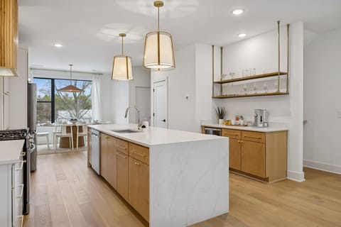 Kitchen: Sleek lines, warm tones, and high-end touches — the perfect kitchen for cooking, entertaining, and enjoying life together.