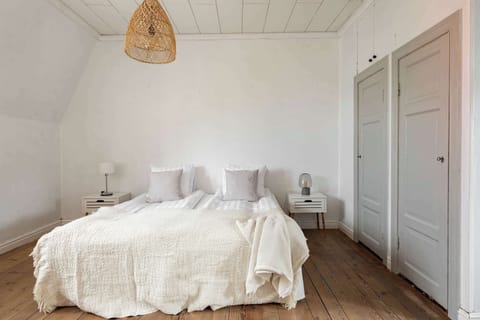 View of the bed and ample clothing space. 