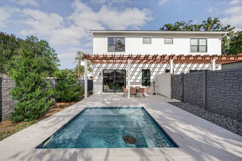 The inviting exterior of the vacation home showcases a modern design with an adjacent pool, ideal for family gatherings.