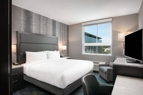 Unwind in a serene king bed with daylight views.
