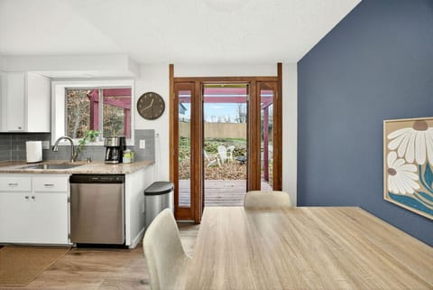 Airy kitchen and dining area with access to the fenced yard