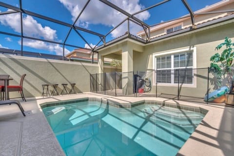 Another angle of the screened pool showing ample deck space and relaxing seating.
