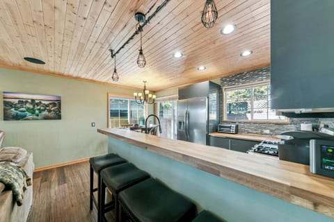 Stylish open kitchen with a spacious breakfast bar, modern appliances, and warm lighting—ideal for casual meals and relaxed conversations.
