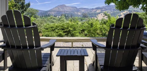 Unwind on the scenic deck with cozy chairs, fire table, and sweeping valley views - ideal for coffee at sunrise or relaxed evenings outdoors.