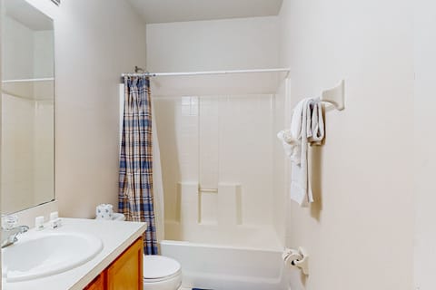 The guest bathroom has a shower/tub combo, vanity, and toilet that serves both guest bedrooms.