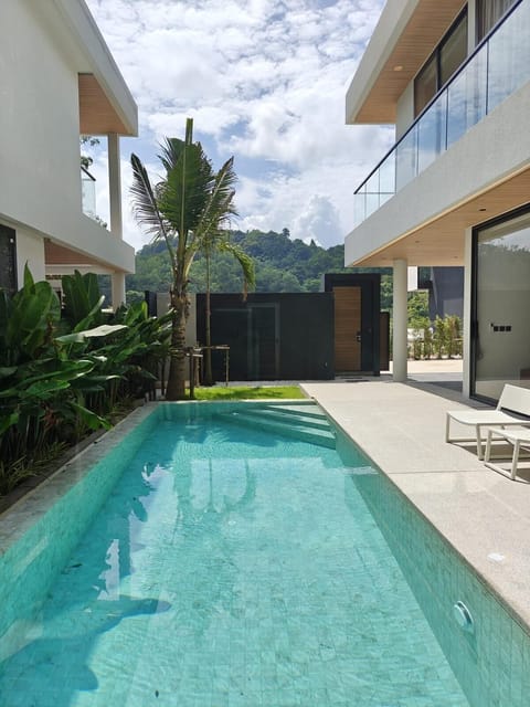 Inviting pool view framed by modern villa architecture, creating a true resort-style atmosphere.