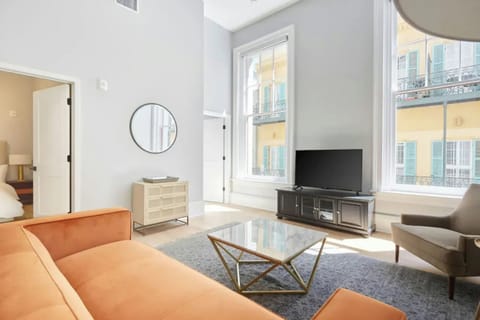 Living room with plush seating and a TV. (Unit 3)