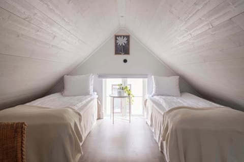 The cozy main bedroom with two comfortable 90 cm beds that can be separated or combined to form a 180 cm wide bed. The tiled ceiling gives the room a cozy character.  There is good storage space in the closet. 